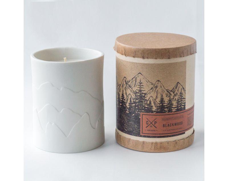White porcelain candle with mountains that glow while the candle burns. Fragrances inspired by the outdoors.