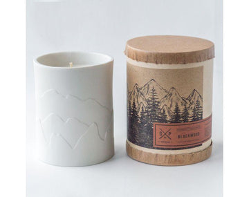 White porcelain candle with mountains that glow while the candle burns. Fragrances inspired by the outdoors.