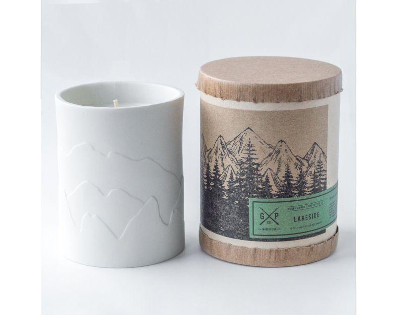 White porcelain candle with mountains that glow while the candle burns. Fragrances inspired by the outdoors.